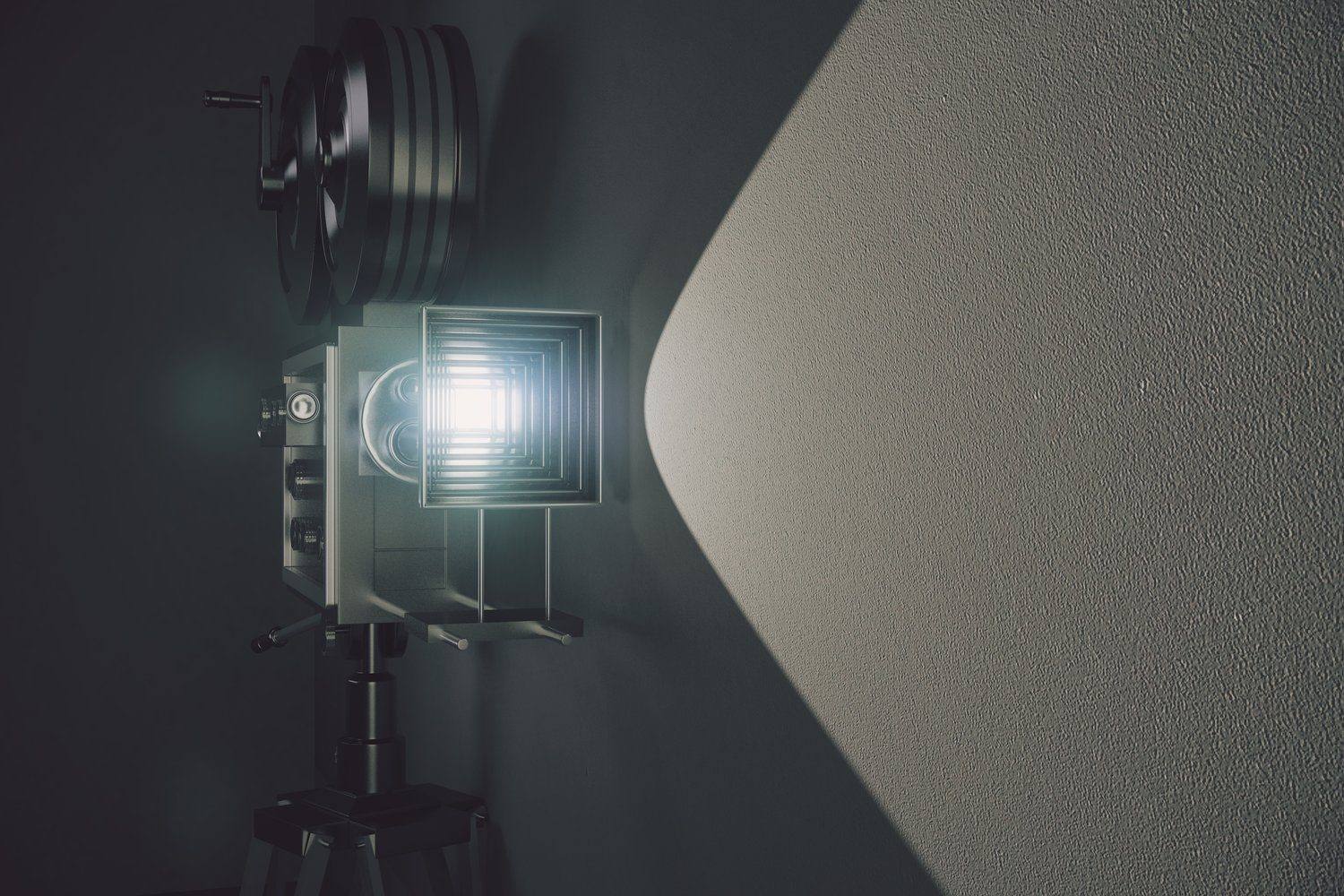 Stary projektor filmowy rzucający snop światła w ciemnym pomieszczeniu